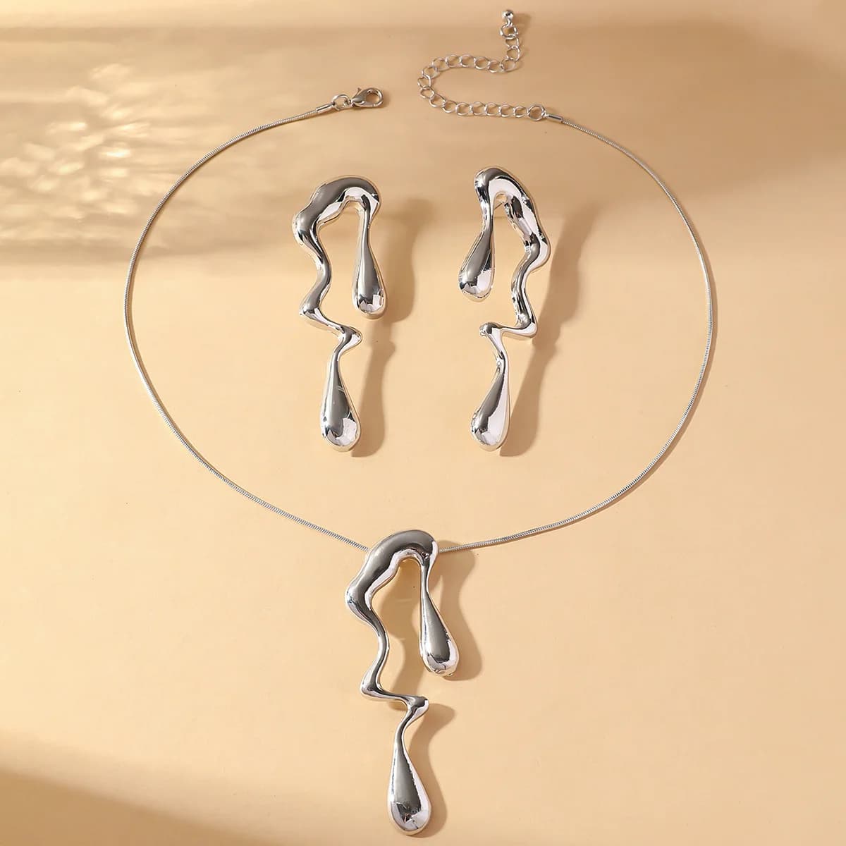 Ensemble de bijoux en métal irrégulier, élégant et raffiné, avec des motifs géométriques ajourés en 