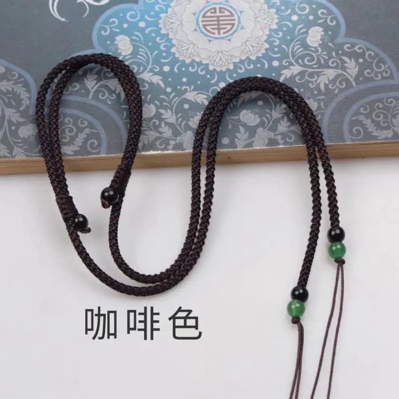 Collier pendentif avec perles Dzi attachées à un cordon